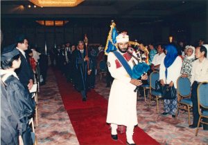 A piper leads the official party into Otago's first Malaysian graduation, held 26 April 1997 in Kuala Lumpur. From University of Otago International Office records, MS-3522/002, S13-561a, Hocken Collections.