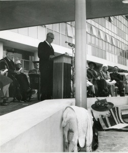 An uninvited guest at the official opening of the Dental School, 4 March 1961. Minister of Education Blair Tennent is speaking, with University Chancellor Hubert Ryburn seated at left. Photograph courtesy of Peter Innes.