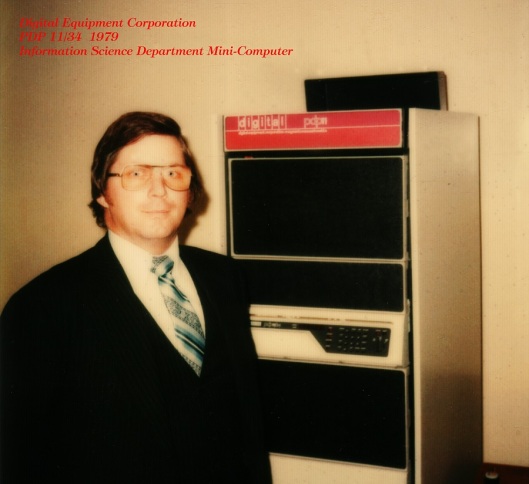 Hank Wolfe with the Department of Quantitative and Computer Studies computer - a PDP 11-34 - in 1979. Image courtesy of Hank Wolfe.