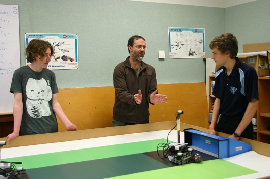 Anthony Robins teaching in the robotics lab in 2012 with Otago student Louis Lepper (left) and Philip Anderson of Kings' High School (right). They are training for the Robocup soccer event. Photograph courtesy of Anthony Robins.