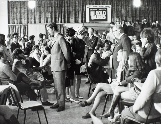 Prince Charles and Princess Anne meet Otago students in the University Union. Accompanying the princess is Laraine Waters, the "lady vice-president" of OUSA. Image courtesy of the Hocken Collections, University of Otago Registry records, AG-180-072/021, S14-561b.