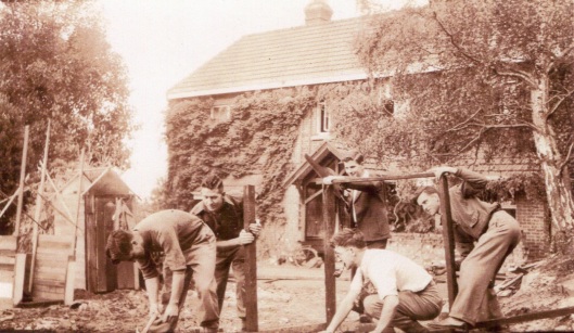 Building a float for the 1946 capping procession, in front of the first house purchased for Carrington. The man with saw in hand is Murray Menzies, who became a surgeon. Image from Pat Menzies, courtesy of Carrington College.
